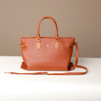 Side profile of brown Saule Tote – elegant leather tote with reinforced corners and detachable strap