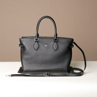 Front view of black Saule Tote – designer leather bag handcrafted for modern utility and straps