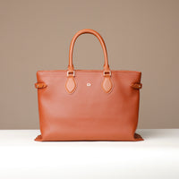 Angled view of brown Saule Tote – structured silhouette with side strap and premium stitching