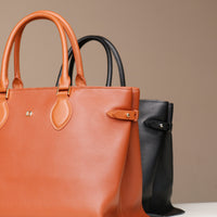 Saule Tote hardware and handle detail – close-up of black and brown leather finishes and polished hardware