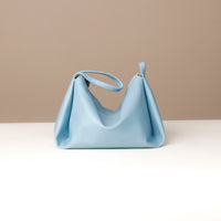 Close-up of Danilo’s logo on blue leather Silueta – premium craftsmanship detail