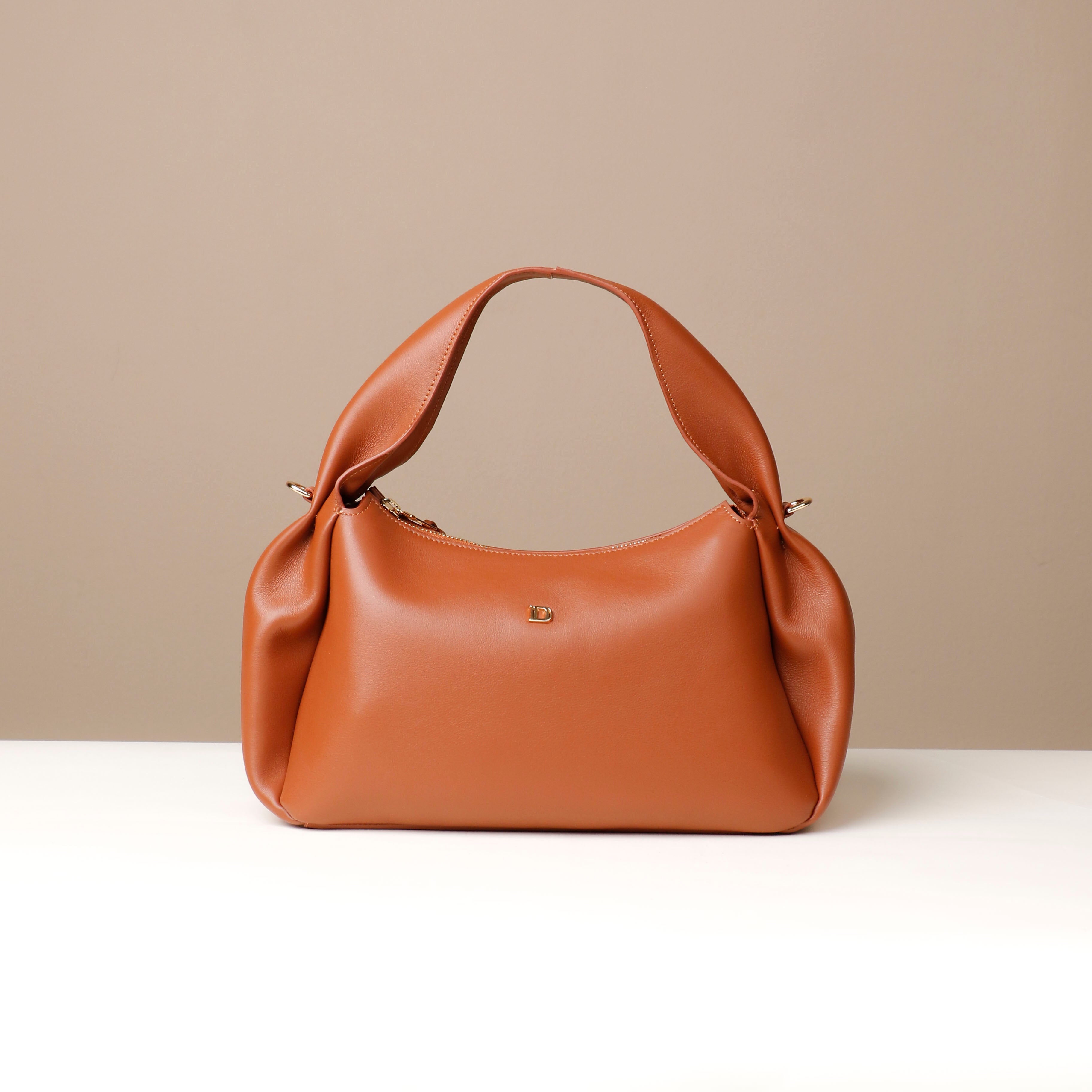 Brown Aurora Soft Bag – smooth sculpted silhouette with crossbody versatility