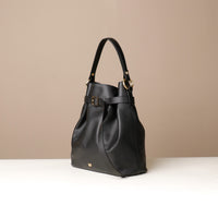 Angled View of Black stylish leather handbag with a structured silhouette and versatile design, perfect for everyday wear and special occasions.