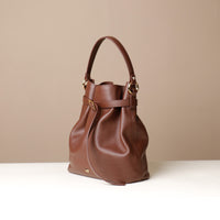 Angled View of Maroon stylish leather handbag with a structured silhouette and versatile design, perfect for everyday wear and special occasions.