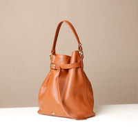 Angled View of Brown stylish leather handbag with a structured silhouette and versatile design, perfect for everyday wear and special occasions.