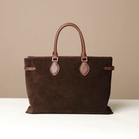 Brown suede leather danilos  tote bag with matching handles and strap on a beige background