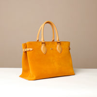 Yellow suede leather danilos  tote bag with yellow handles on a beige background