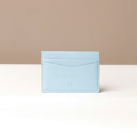 A blue card holder with the brand name 'Patrick' displayed on a neutral background.