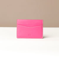 A magenta-colored Patrick card holder made from premium leather, displayed against a neutral background.