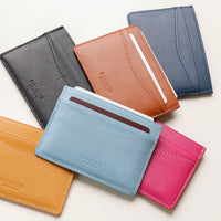 Collection of colorful leather card holders on a white background