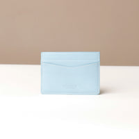 Light blue cardholder on a beige background