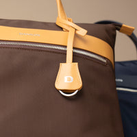 closeup-messenger-crossbodybag-ballistic-nylon-leather-details-transiktrek-brown-with-yellow-with-silver-hardware-front-view-with-visible-brand-danilos