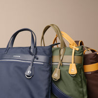 three-messenger-crossbodybag-ballistic-nylon-leather-details-transiktrek-green-brown-with-yellow-navy-front-view