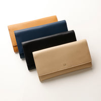 Four wallets in different colors arranged on a white background