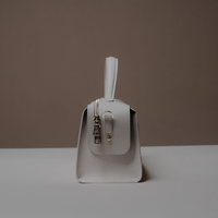 Side View of White Avela Bag with top handle and detachable strap