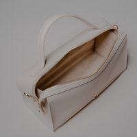 Top Open View of White Avela Bag with top handle and detachable strap