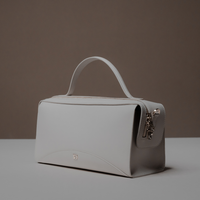 Angled View of White Avela Bag with top handle and detachable strap