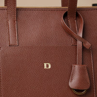 Close up view of brown Emma Pebble Leather Tote Bag by Danilos