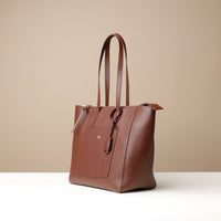 Side view of brown Emma Pebble Leather Tote Bag by Danilos