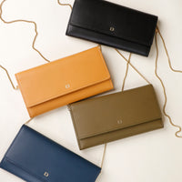 front view of four danilos clutch versaviva in yellow, black, green and blue with chain strap in a white background