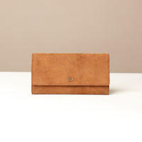 Brown suede leather Danilos wallet with a gold logo on a beige background