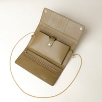 Open beige Danilos clutch wallet with a chain strap on a light background