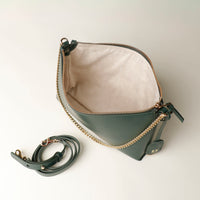 opened Green Danilos handbag with gold chain strap on a white background