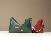 Two Danilos handbags, one green and one red, with gold chains on a beige background.
