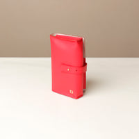 side view of a red Danilos Pebble executive accessory holder linea on a beige background