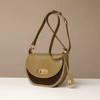 Two-tone Danilos handbag with a gold clasp on a beige background