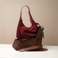 Two handbags top-handle tote, Mia Minimale, suede leather, one red and one brown, on a beige backgrounde