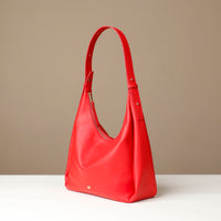 Red handbag on a beige background