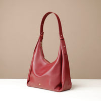 Red handbag on a beige background
