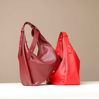Two red handbags on a beige background