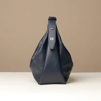 Mia Minimale Jr marine blue handbag with a visible brand logo Danilos on a beige background