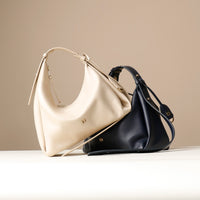 Two handbags, Mia Minimale Jr, one beige arena and one black, on a neutral background