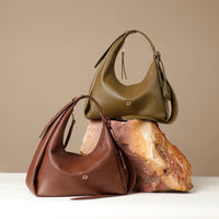 Two mini Mia Jr handbags in colors brown and green over a yellow rock in a beige background
