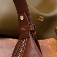 close-up view of a brown leather Mini Mia Minimale with the Danilos logo on it