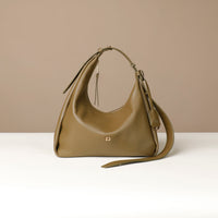Front view of a olive green leather Mini Mia Minimale Danilos handbag with a strap on a beige background