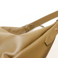 Close-up of a olive green leather bag with a gold zipper and 'Danilos' branding on a white background