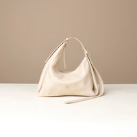 Front view of a white green leather Mini Mia Minimale Danilos handbag with a strap on a beige background