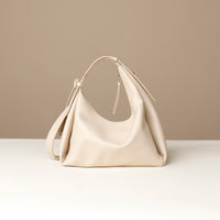 back view of a white green leather Mini Mia Minimale Danilos handbag with a strap on a beige background