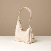 Front view of a white green leather Mini Mia Minimale Danilos handbag with a strap handle on a beige background