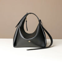 Front view of a Black leather Mini Mia Minimale Danilos handbag with a strap on a beige background