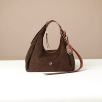 Brown handbag with a strap on a beige background