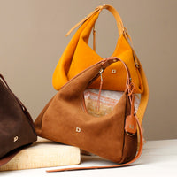 Two handbags, one brown and one yellow, on a neutral background