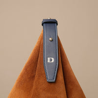 Compact suede hobo bag with sculptural lines and refined design
