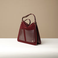Side view of Red Suede Penelope Sr. bag in Brown with fold-over magnetic closure