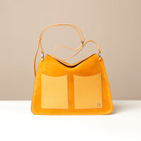 Yellow handbag with woven detail on a beige background