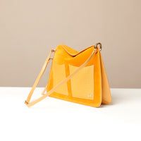Yellow handbag with a textured pattern on a beige background